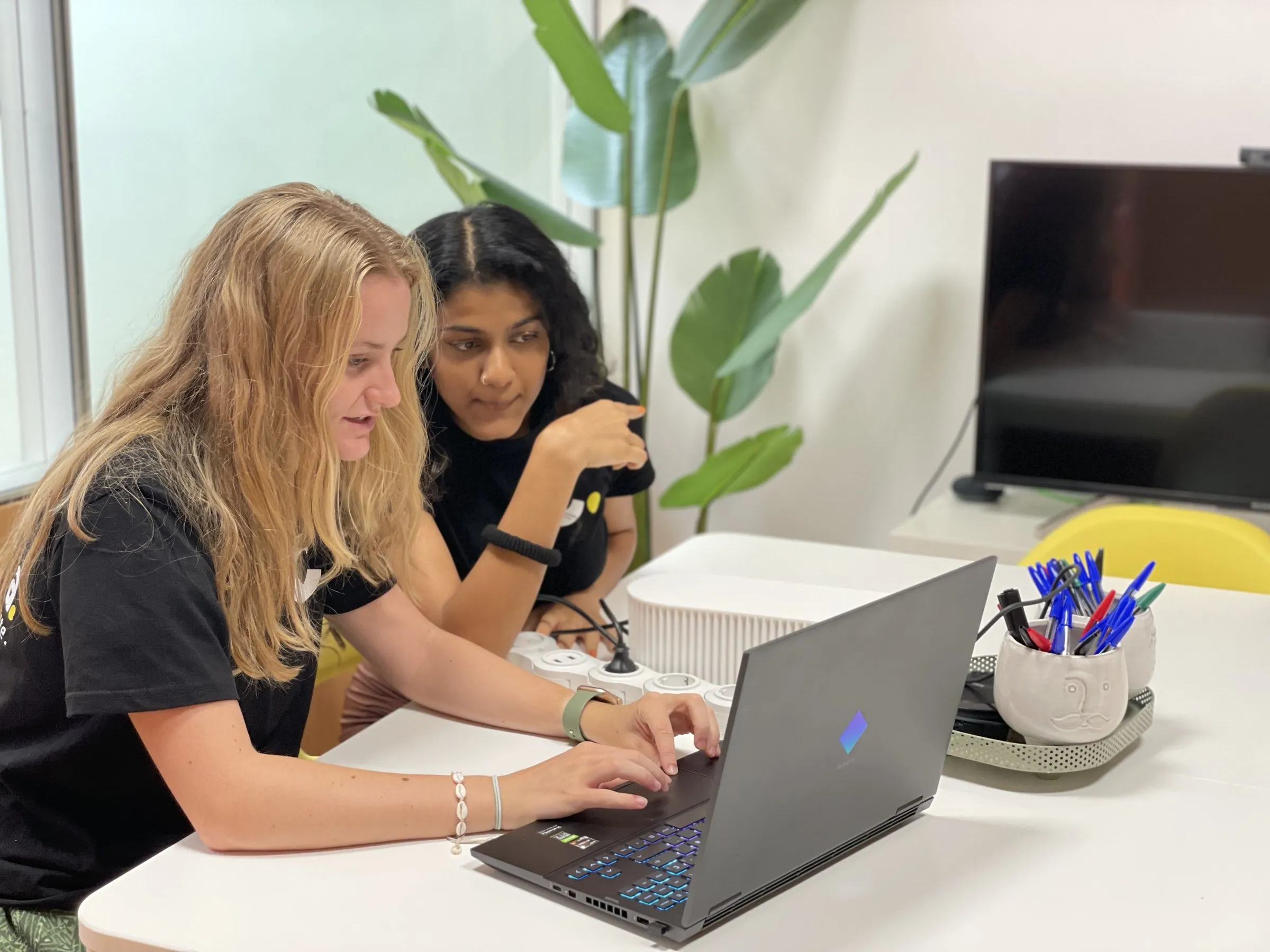 Two Calima team members working together on a laptop