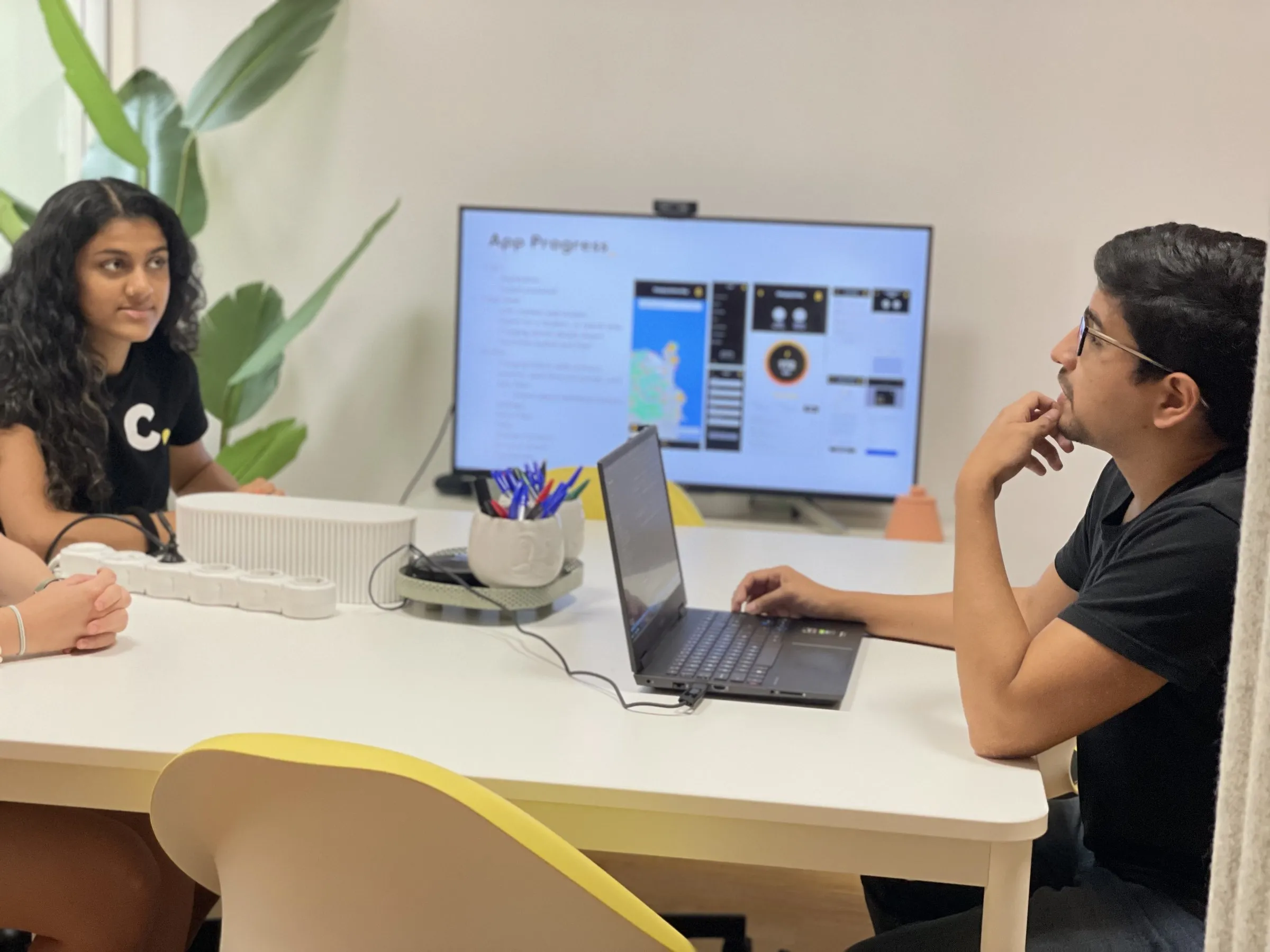 A project review at Calima, with the progress of an app on the screen
